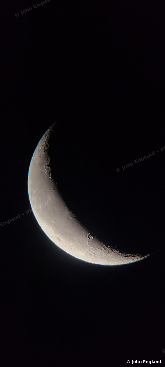 Broad Crescent Moon – Thick crescent moon on black, vertical.
