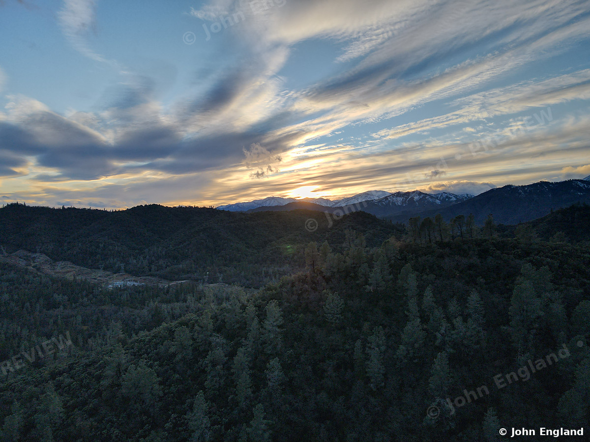 Clouded Forest Hills – Aerial of forest hills under dramatic clouds, Shasta County area.