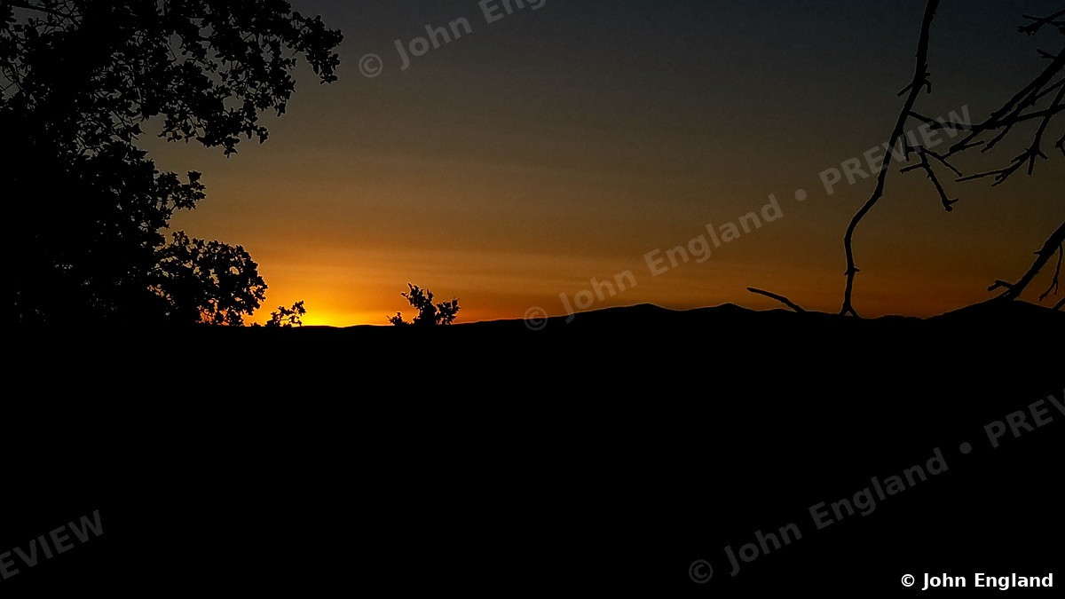 Ember Sunset – Deep orange sunset over a silhouetted ridge, Northern California, Jun 21, 2019.