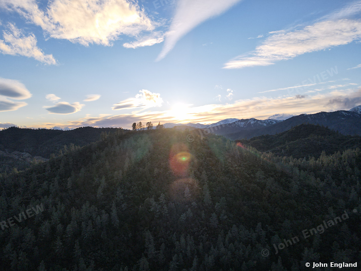 Forest Ridge Sunrise – Aerial sunrise over forested ridges, Shasta County area.