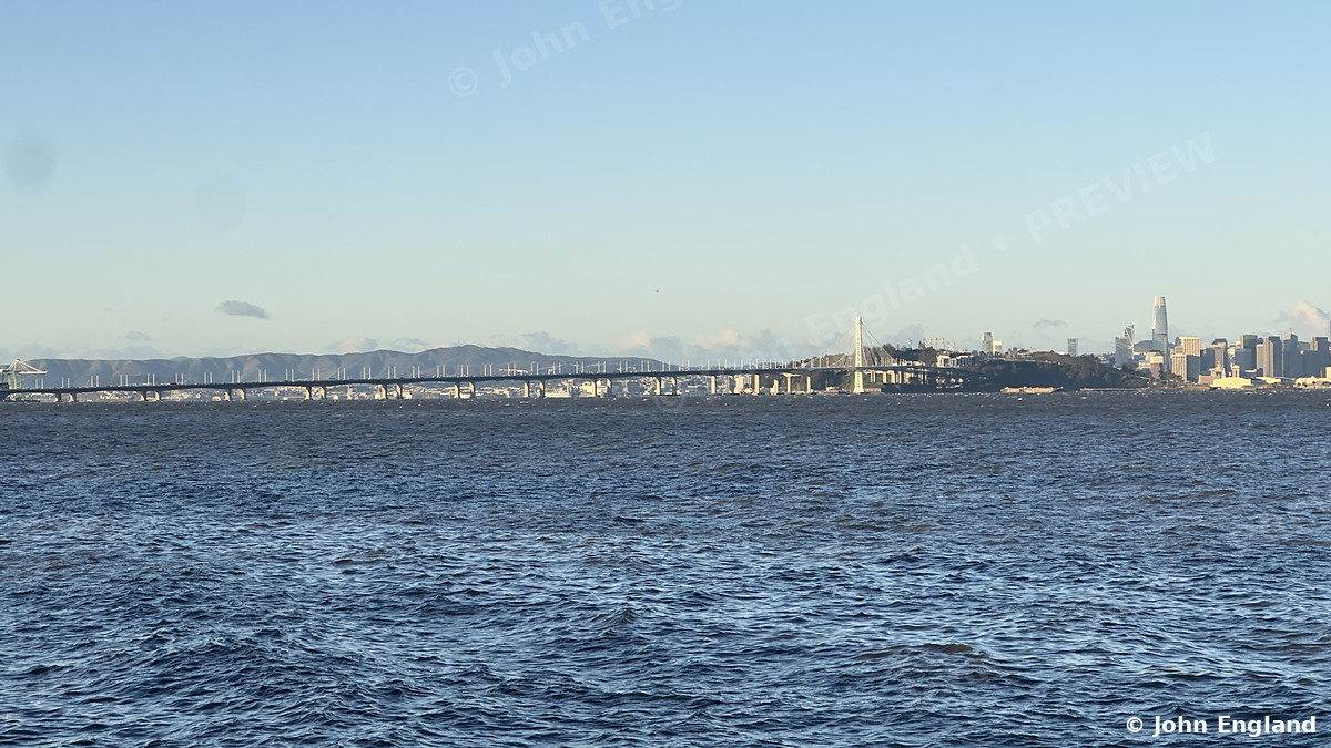 Bay Bridge Morning, San Francisco – San Francisco skyline and Bay Bridge across the Bay from the Berkeley shore at sunrise.