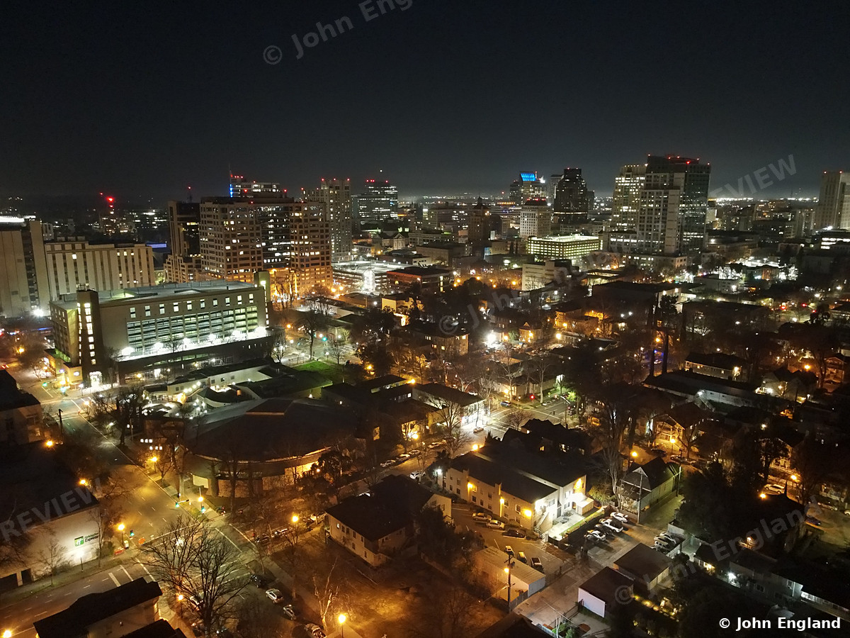 Downtown Night Lights – Aerial night view of downtown buildings and streets.