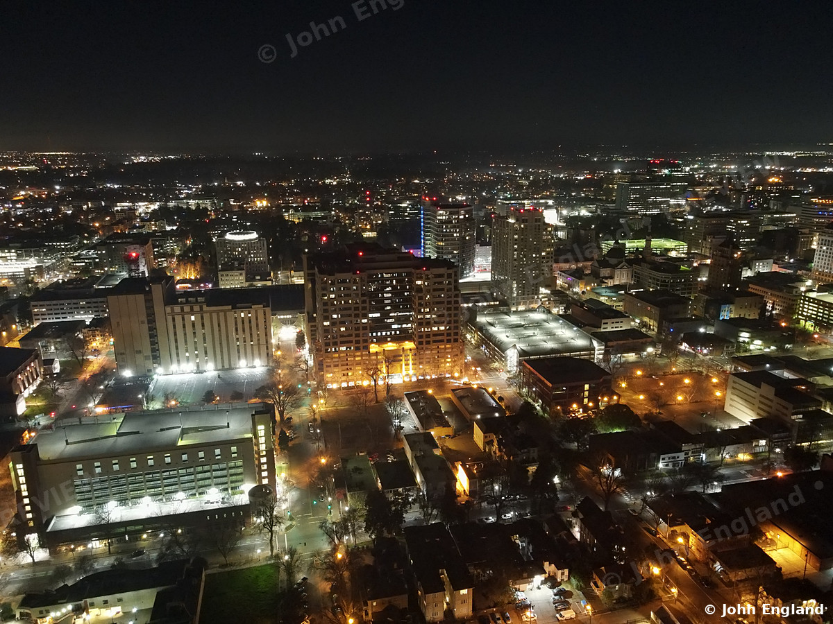 Night Grid Downtown – Aerial night view of lit downtown blocks.