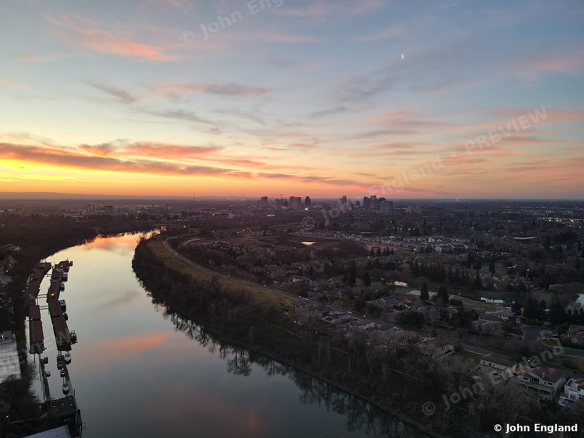 River Bend at Golden Hour – Aerial of the river curving under a glowing sunset sky.