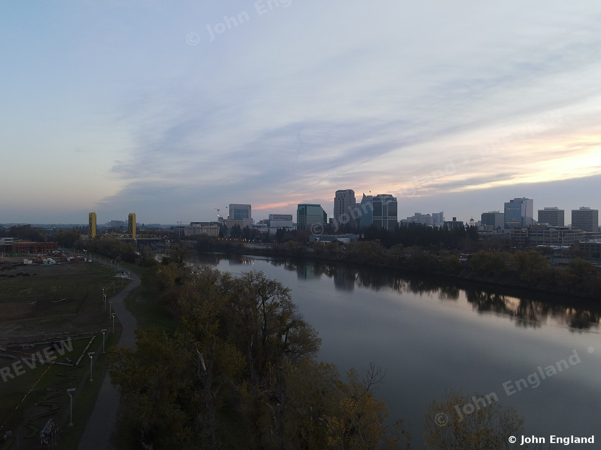 River Dusk Skyline – Aerial dusk view of the river curving toward the downtown skyline.