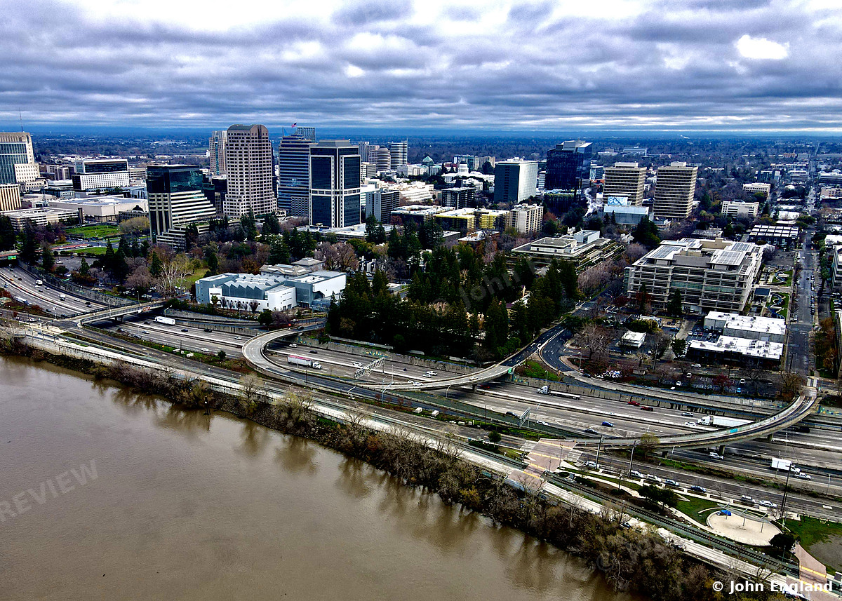 Sacramento River and Downtown, Aerial – Aerial view over the Sacramento River and freeway toward downtown Sacramento, CA. Dec 16, 2021. John England.