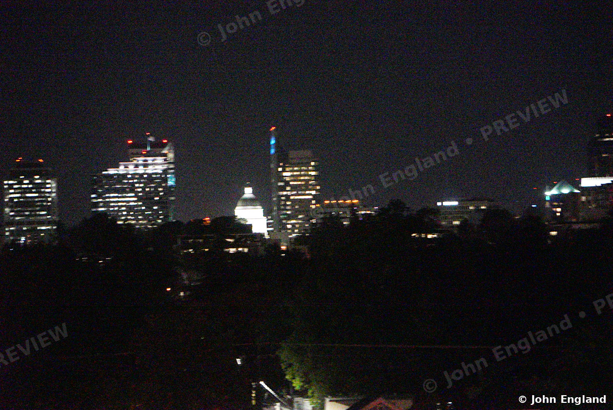 Capitol Dome Among the Night Towers – Downtown skyline at night across the trees, May 17, 2021.