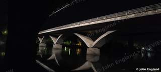 Arched Bridge at Night – Arched bridge at night with reflections.
