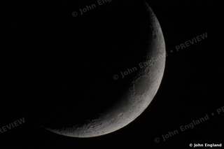 Slender Crescent Moon – Thin crescent moon on black sky.