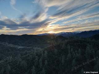 Clouded Forest Hills – Aerial of forest hills under dramatic clouds, Shasta County area.