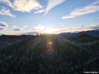 Forest Ridge Sunrise – Aerial sunrise over forested ridges, Shasta County area.