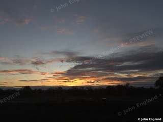 Valley Sunset Clouds – Dramatic sunset clouds over a flat Northern California tree line.