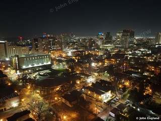 Downtown Night Lights – Aerial night view of downtown buildings and streets.