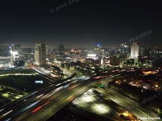 Freeway Light Trails into Downtown – Aerial night shot of freeway interchange light trails leading into the Sacramento skyline.