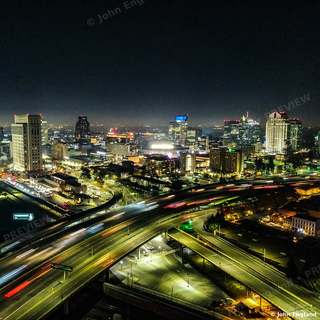 Freeway Light Trails, Sacramento – Night freeway light trails below the downtown Sacramento skyline, CA. Dec 2021. John England.
