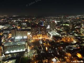 Night Grid Downtown – Aerial night view of lit downtown blocks.