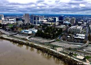 Sacramento River and Downtown, Aerial – Aerial view over the Sacramento River and freeway toward downtown Sacramento, CA. Dec 16, 2021. John England.