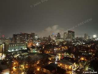 Sacramento at Night from Above – Aerial view of downtown Sacramento at night under low clouds, Sacramento, CA. Dec 2021. John England.