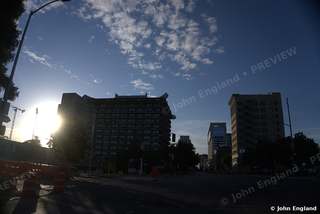 Sunrise Between the Towers – Sunburst between downtown buildings at dawn, May 2021.