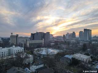 Sunset Sky over Midtown – Aerial of streaked sunset clouds above midtown and downtown towers.