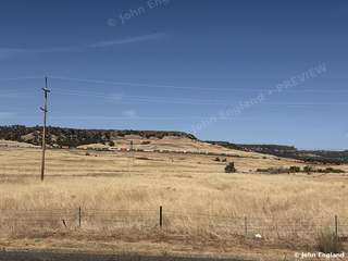 Golden Grass Below the Mesa, Butte County – Golden summer grassland and a passing freight train below a flat-topped mesa north of Oroville, Butte County. Aug 26, 2026. John England.